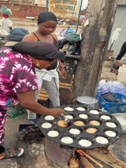 Women prepare street food outdoors in Jos, Nigeria