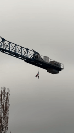 Blue crane displays UK flag in Laval, Canada