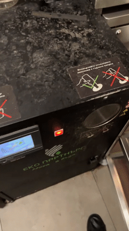 Person recycles glass bottles at Sofia vending machine