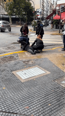 Bystanders assist man on Buenos Aires sidewalk