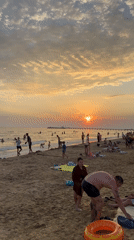 Crowded Black Sea beach at golden hour, Anapa