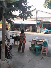 Street life and food stalls buzzing through a Surakarta neighborhood
