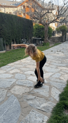 Girl cartwheels among spring blooms in Benasque, Spain