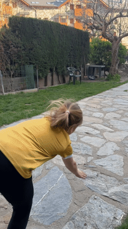Girl cartwheels among spring blooms in Benasque, Spain