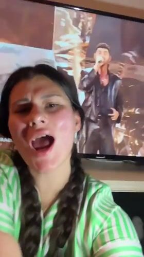 Woman films video at home in Kiryat Bialik