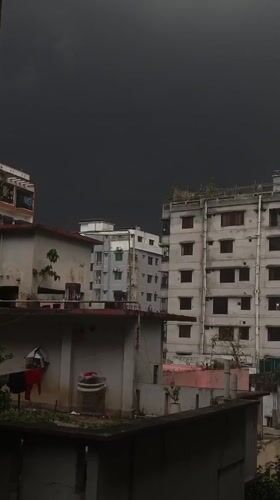 Overcast skies signal approaching storm in Dhaka neighborhood