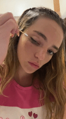 Woman applies makeup in early morning beauty routine