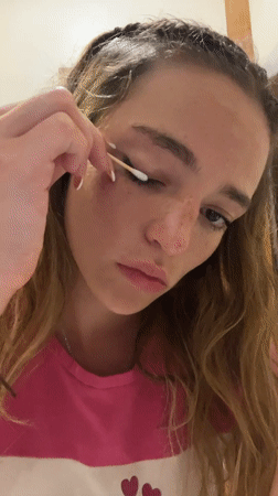 Woman applies makeup in early morning beauty routine