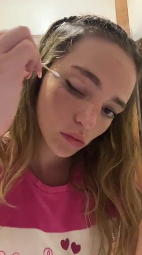 Woman applies makeup in early morning beauty routine