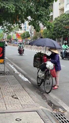 Fruit vendor sells produce on Ho Chi Minh City street