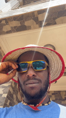 Man in straw hat documented at Abuja home studio