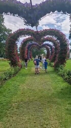 Heart-shaped floral arches line a garden path in Lithuania