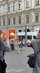 Street guitarist performs on Saint Petersburg sidewalk