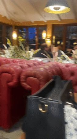 Woman dines at Bremen restaurant with pizza menu