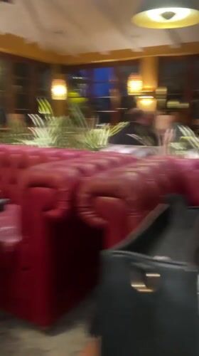 Woman dines at Bremen restaurant with pizza menu