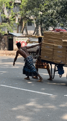 Two men transport packages by hand cart in Dhaka