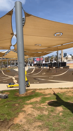 Boy attempts scooter tricks at Tel Aviv skate park