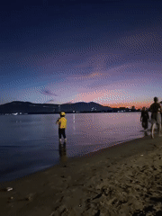 Da Nang coastline at dusk, city lights emerging over water