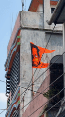 Street life documented in Bhadrapur: decorated building, boy on tricycle