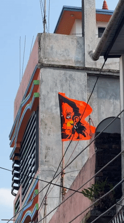 Street life documented in Bhadrapur: decorated building, boy on tricycle