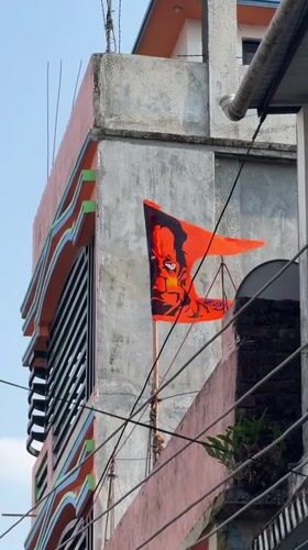 Street life documented in Bhadrapur: decorated building, boy on tricycle