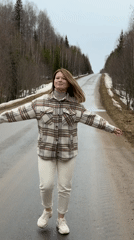 Woman dances, lies on empty road in Zasechnyi, Russia