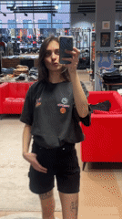 Woman photographs herself with skateboard in Krasnoyarsk store mirror