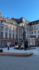 Masked street artist spray paints public art in Kazan square