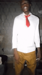 Young man recorded speaking animatedly indoors wearing shirt, tie