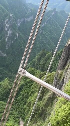 Cable car passenger films green mountain scenery in Yongding District