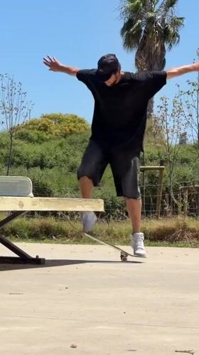 Skateboarder performs ping pong table tricks in Viladecans park