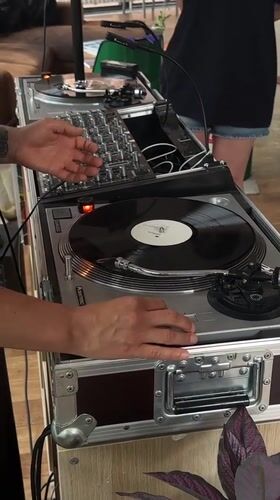 DJ performs with turntables and mixer in Kiel