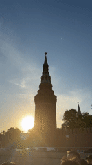 Woman sightseeing by boat near Moscow Kremlin during sunset