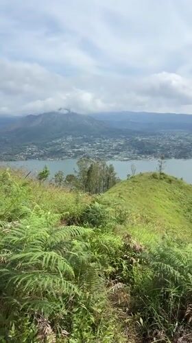 Hiker documents scenic lake views in Kintamani, Indonesia