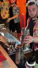 Hawaiian-themed bartenders serve cocktails at busy Moscow bar