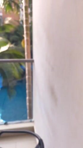 Pool with waterslide observed from balcony in Pattaya