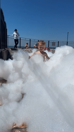 Kids and adults enjoy a sunny Sochi waterfront morning