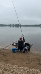 Early morning angler fishes river bank in Chaikovsky, Russia