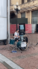Street drummer performs on green kit in Moscow