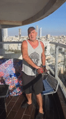 Family barbecue gathering documented on Bat Yam balcony