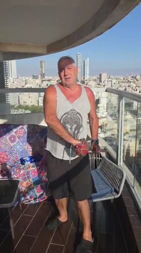 Family barbecue gathering documented on Bat Yam balcony