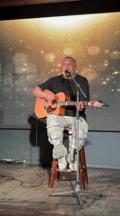Acoustic guitarist performs at Chaikovsky bar as patrons dance