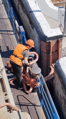 Cargo barge transits canal lock system with crew operations