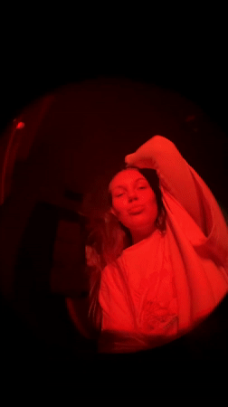 Woman dances under red lights in Belgrade, hashtag trending