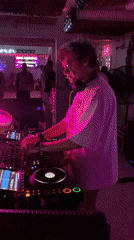 DJ working the decks in a dimly lit Ko Samui club