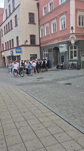 Traditional Bavarian gathering on Ingolstadt cobblestone street