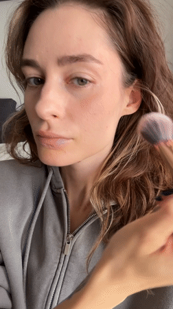 Woman applies makeup during morning routine in Kiel