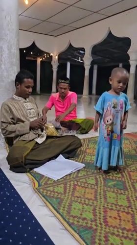 Inside a mosque in Keudejungkagajah, traditional dress and arched pillars
