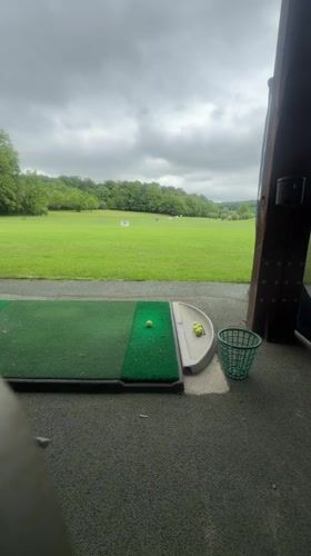 Golfer practices at Lenningen driving range, Luxembourg