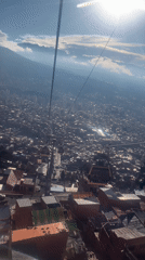 Cable car rider films La Paz cityscape from above